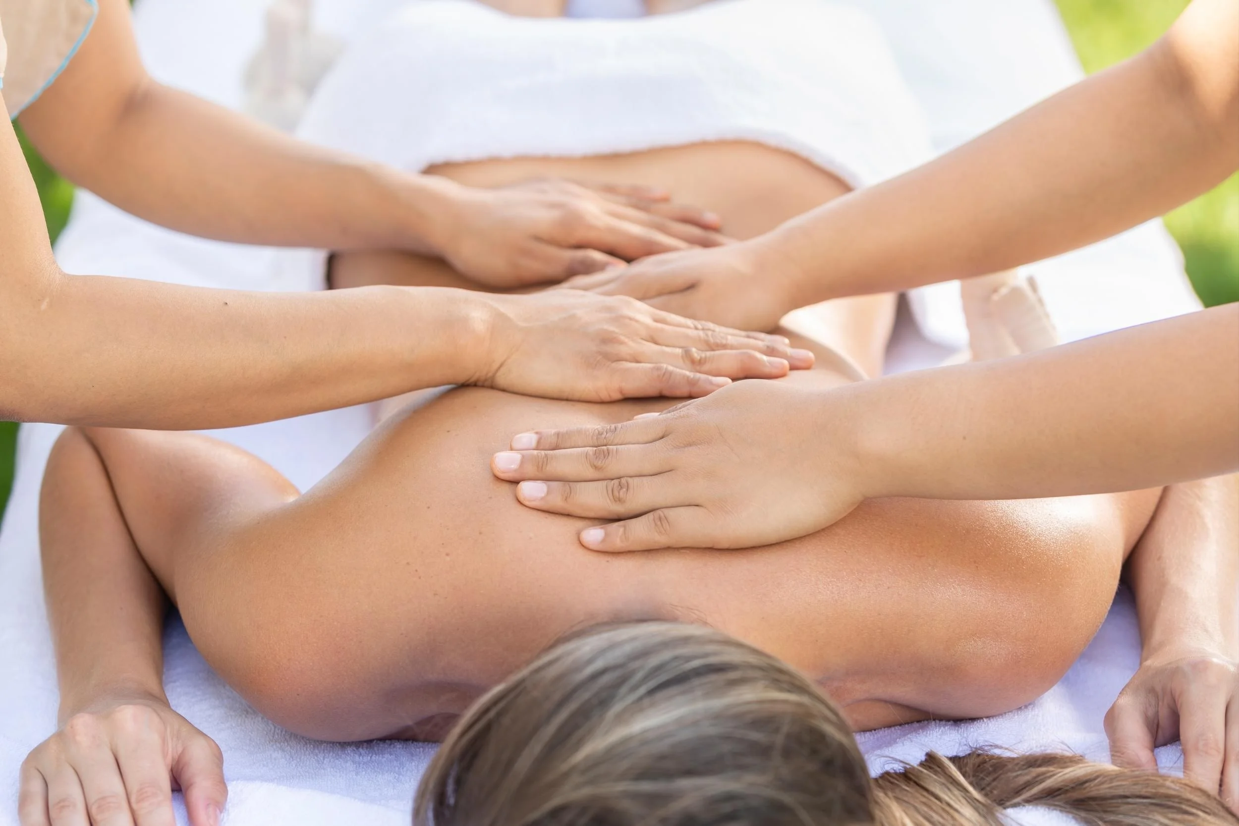 Four hand massage with two therapists